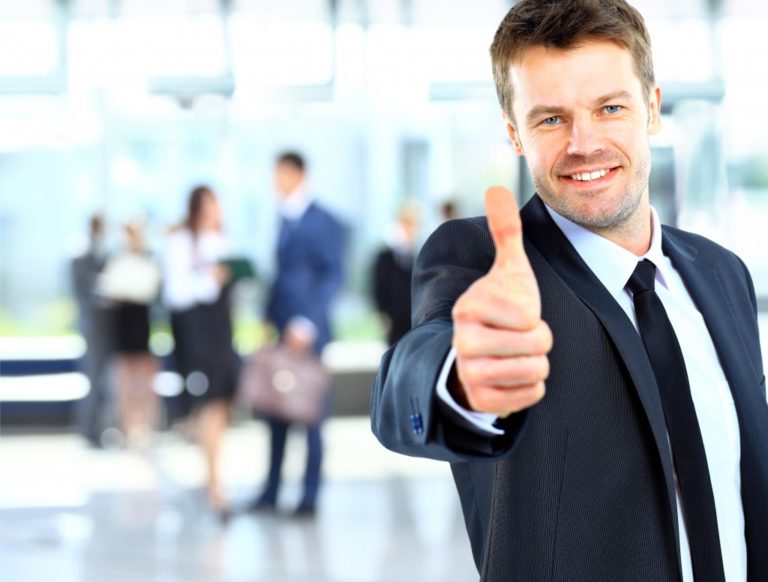 Businessman giving thumbs up