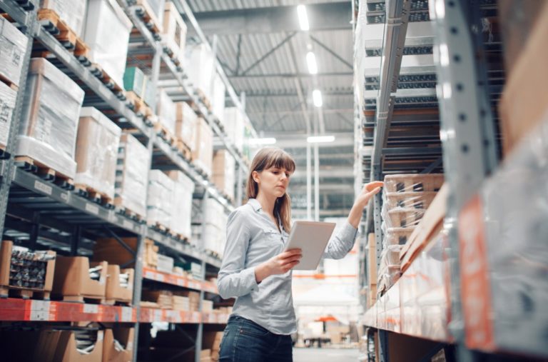 businesswoman looking through warehouse records