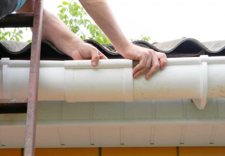 Man installing rain gutter