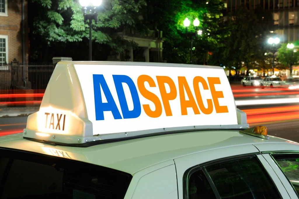 Taxi billboard close-up at night