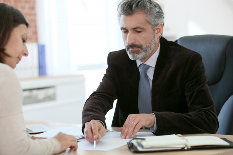 woman signing a document