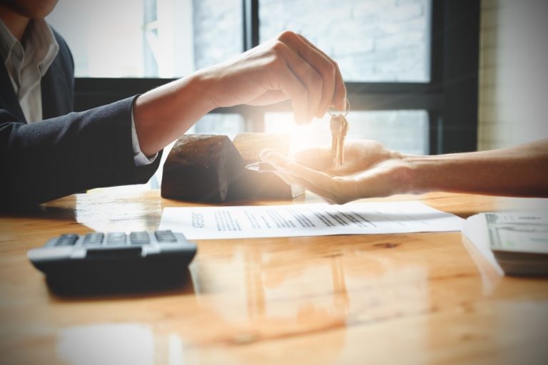 man handing a home key