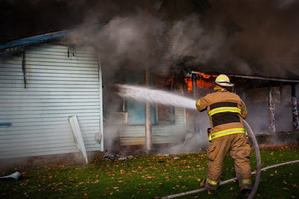 fireman putting out fire in a house
