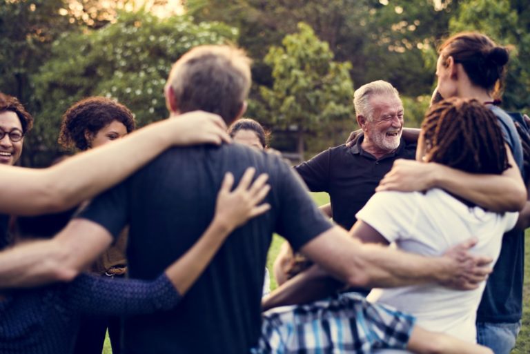 group of diverse people huddling