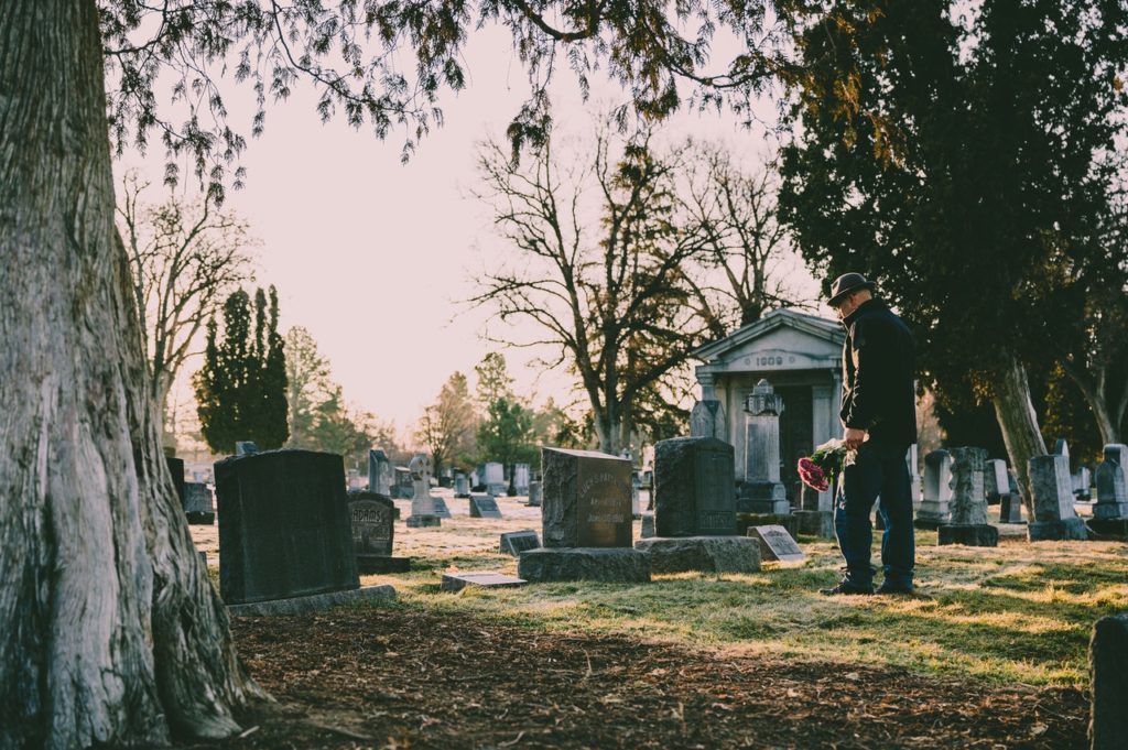 man at a graveyard