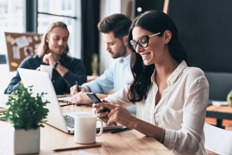 woman using her phone at work